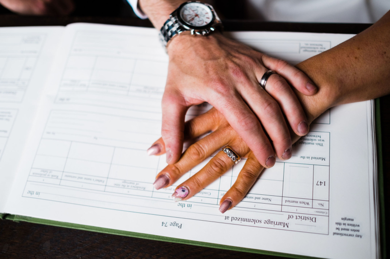 A pair of hands over a wedding register